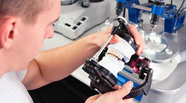 Man using computer aided design (CAD) to manufacture a ceramic crown