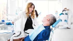 Hygienist talking with a dental patient