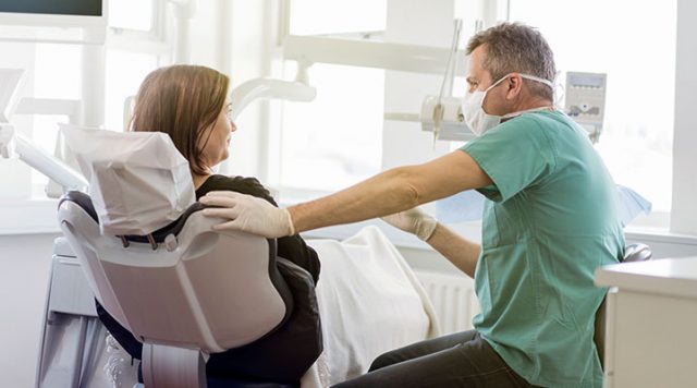 Dentist talking with a patient